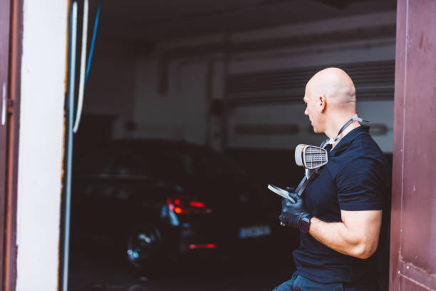 istock Car mechanic in workshop having a break 1550531806