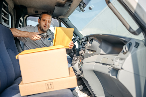 Delivery person using barcode reader to confirm delivery