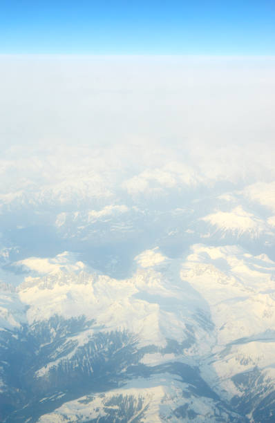 aerial view of snowed mountains. - mountain range earth sky airplane imagens e fotografias de stock