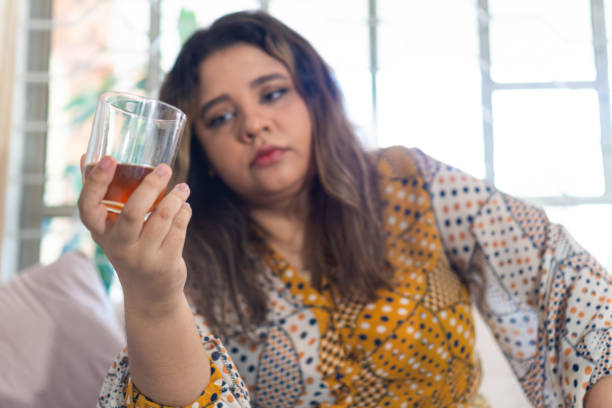 istock Female Examining Whiskey In Glass 1550547241