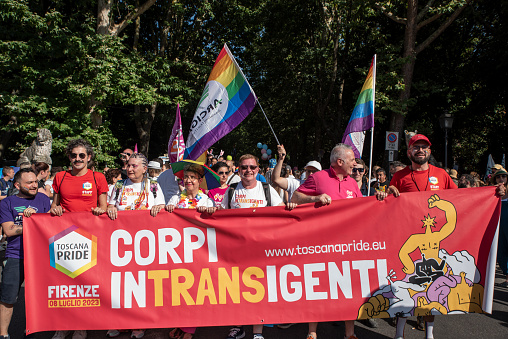 Florence, Italy - 2023, July 8: Crowds of demonstrators holds a banner that reads INTRANSIGENT BODIES, during the “Toscana Pride” LGBTQ  parade