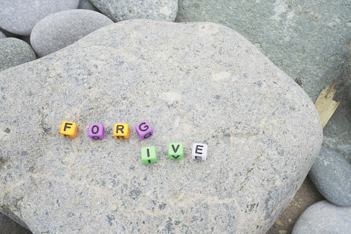 forgive word on pebble stone for background and inspiration