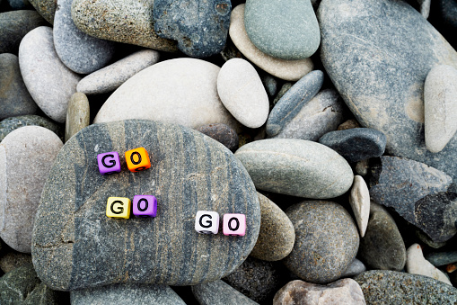 go word on pebble stone for background and inspiration or multiple concept