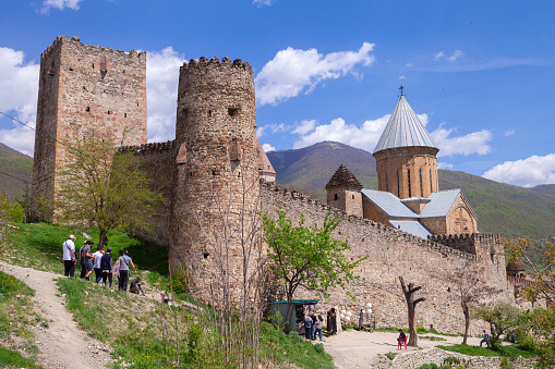 Ananuri, Georgia - April 30, 2019: Tourists visit the Ananuri monastery complex located on the Aragvi River coast in Georgia