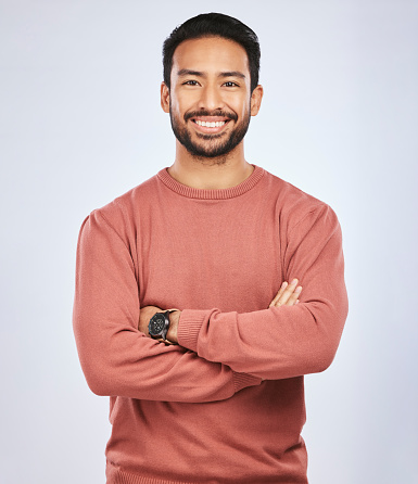 Portrait, happy or confident Asian man with arms crossed or smile in studio in casual fashion or clothes. Relax, satisfied or friendly handsome person smiling on white background with pride or joy