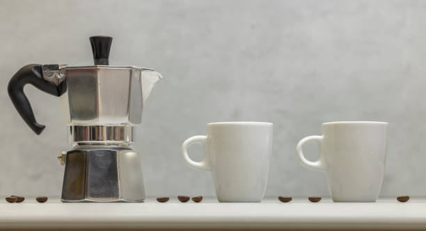 istock Metal geyser coffee maker on table with cup 1550631424