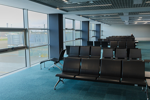 Empty airport terminal waiting area by day - stock photo