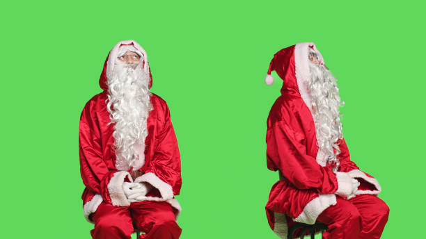 istock Man dressed as santa claus on chair 1550651691