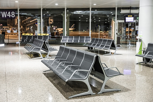 Empty airport terminal waiting area by night- stock photo