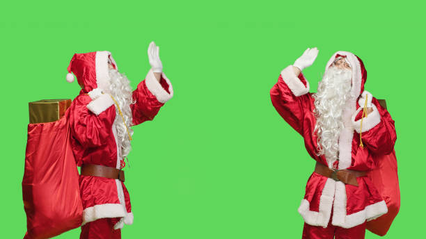 istock Joyful santa waving hello or goodbye 1550653247
