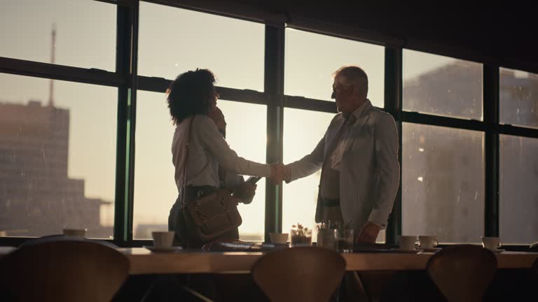 Business people, handshake and morning meeting for teamwork, collaboration or b2b planning at the office. Group of employees or team shaking hands in partnership, deal or agreement at the workplace