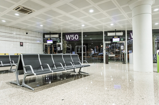 Empty airport terminal waiting area by night- stock photo