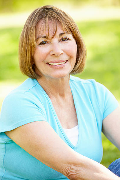 istock Senior Hispanic Woman Relaxing In Park 155067048
