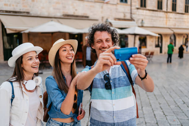 istock Three Young Friends Taking Selfies On The Town Square In Dubrovnik 1550671707