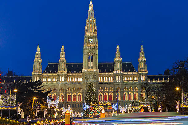 Magnificent Vienna City Hall at night during Christmas The Christkindlmarkt in the Rathausplatz is the most important Christmas Market among the numerous of the city. On the small colorful market stalls you can find ideas for Christmas presents, or traditional Austrian food and sweets with mulled wine ("Glühwein") and Christmas punch. In the background stands the imposing Vienna City Hall, a beautiful example of Gothic Revival architecture. Vienna, Austria. Canon EOS 5D Mark II vienna city hall stock pictures, royalty-free photos & images