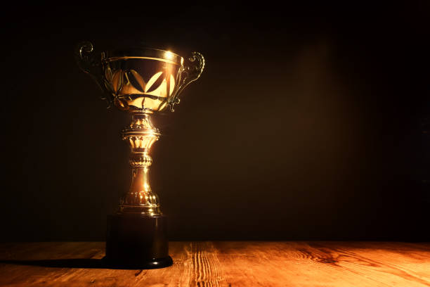 istock low key image of trophy over wooden table and dark background 1550678576