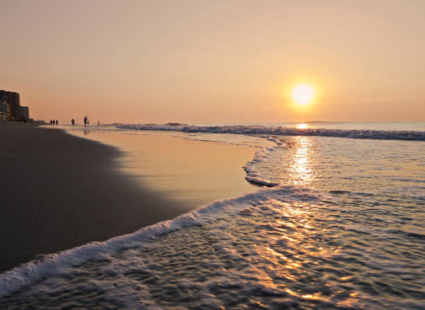 Seascape with fishing rods at sunset