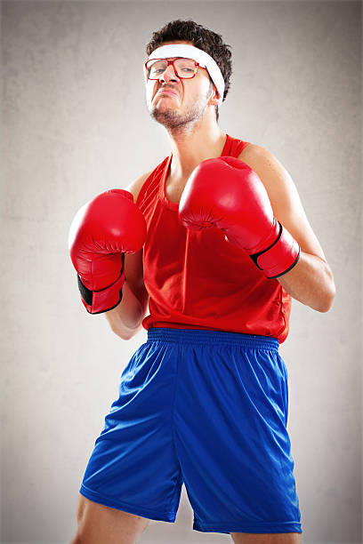 Funny boxer with bad attitude posing over brown background stock photo