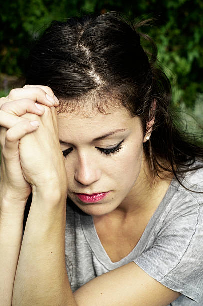 istock Young Woman in Prayer 155068948