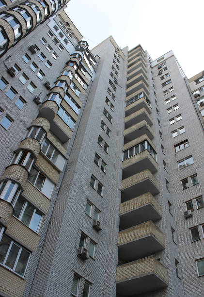 istock Balconies and windows on a facade brick multi storey apartments low point view 1550689798