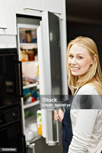 Young Home Maker Checks The Contents Of Her Refrigerator Smiling Stock Photo - Download Image Now