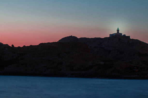 istock Sunset at the Beach in Corsica with Lighthouse 1550703182