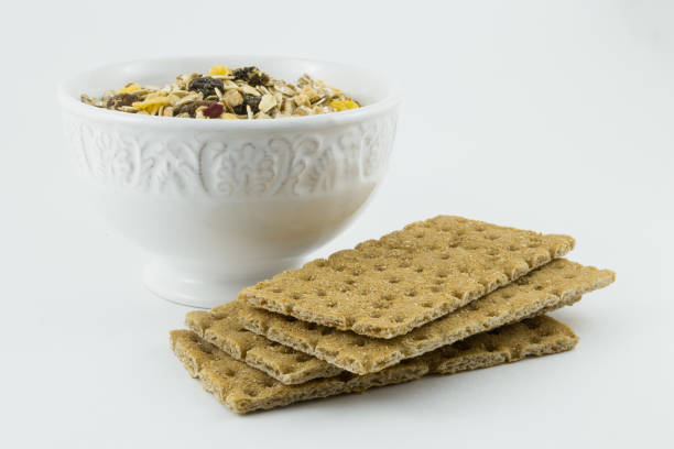 Useful, healthy breakfast. Dietary bread, muesli on a light background. Whole grain bread and muesli with dried fruit is a healthy food without yeast.