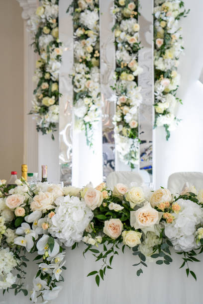 istock Wedding interior restaurant flowers, blossom floral decorations, white bloom for wedding ceremony 1550707015