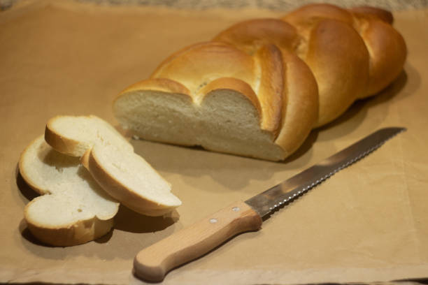 istock braided bread on a light brown background, sliced 1550708731