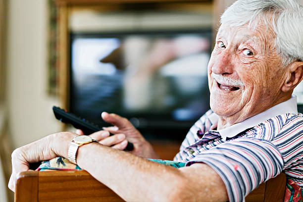 istock This remote control is mine! Senior man happily watching television 155070877