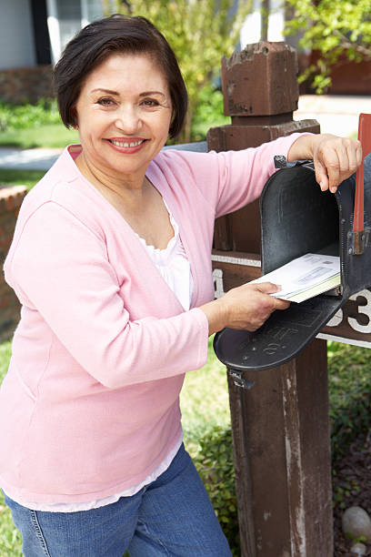 istock Senior Hispanic Woman Checking Mailbox 155071224