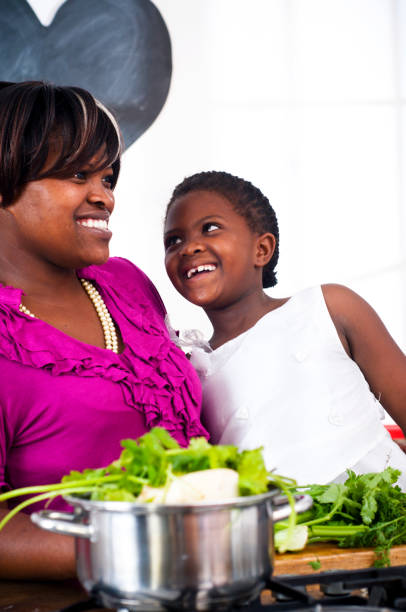 istock Mother and daughter smiling at each other in kitchen 155071648
