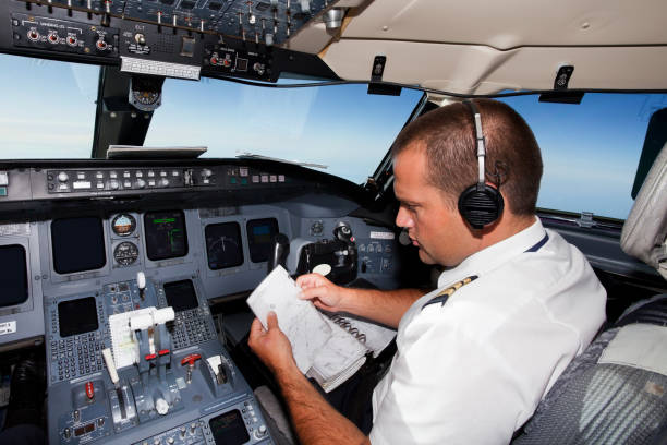 istock Young co-pilot at work in a cabin of commercial jet 155072050