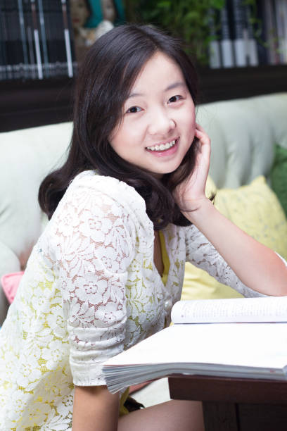 istock Young girl reading Magazine 155072276
