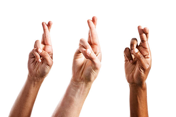 tres superstitious manos con los dedos cruzados, aislado en blanco - fingers crossed fotografías e imágenes de stock