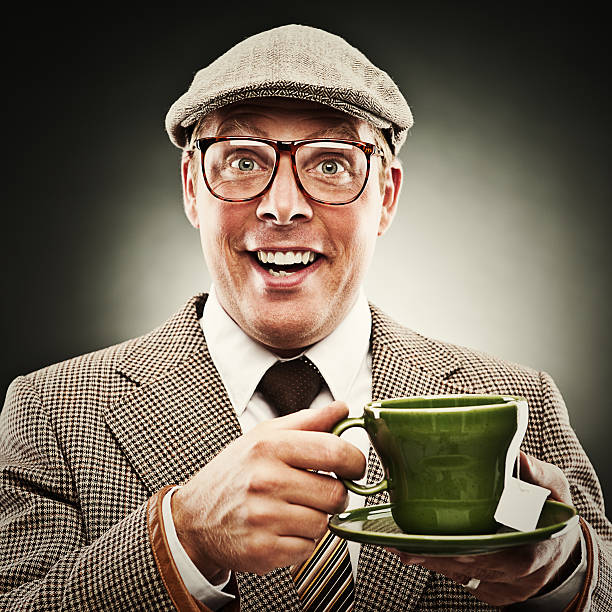 Funny man smiling with tea wearing porkpie hat  tweed stock pictures, royalty-free photos & images