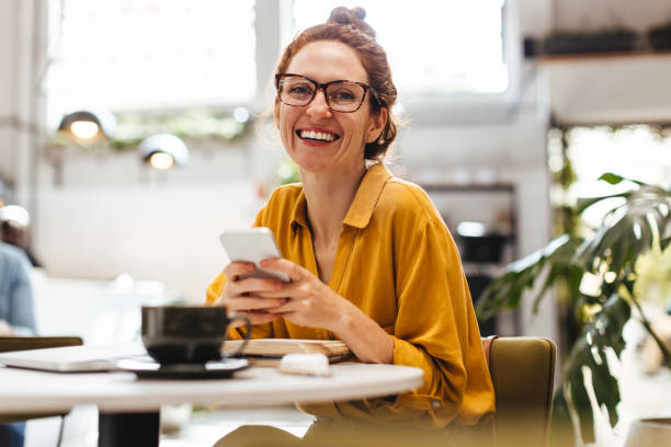 istock Professional woman using a mobile phone in restaurant 1550747722