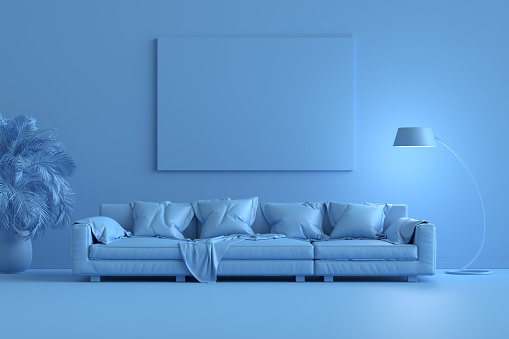 Monochrome blue living room interior with modern leather sofa, mock up poster frame on the wall and a floor lamp.