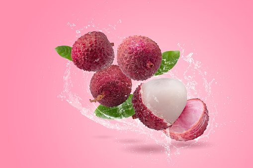 Fresh lychee or litchi fruit isolated on a pink background