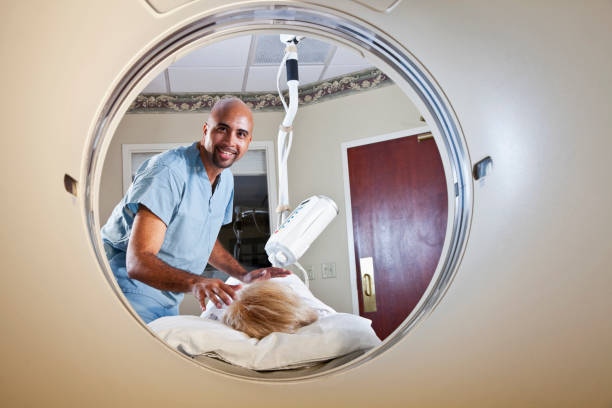 istock Healthcare worker preparing patient for CT scan 155075375