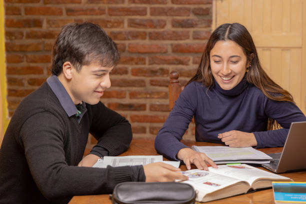 istock Girl and boy students studying for an exam. 1550754273