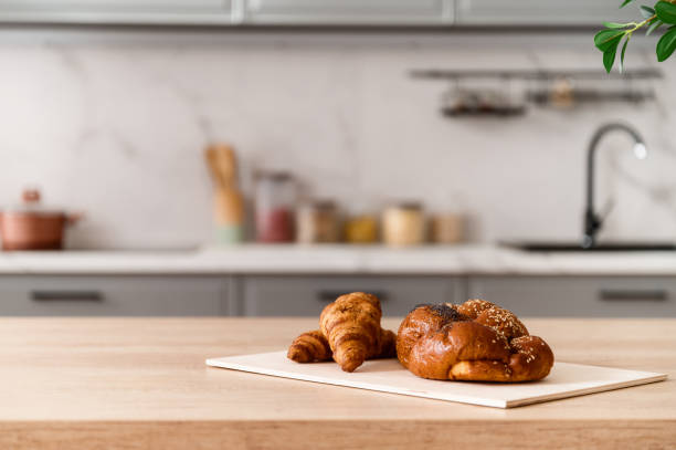 istock Kitchen board with croissants and pastry on wooden table top 1550758860