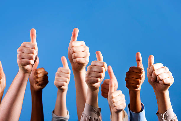 istock Many multiracial hands give group thumbs up of approval 155076379