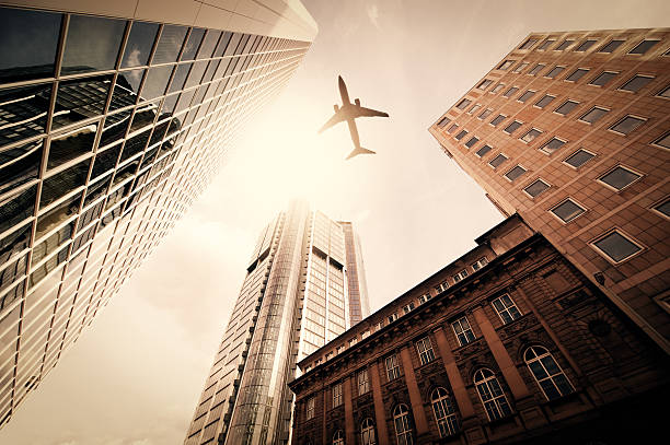 istock Business towers with a airplane silhouette 155076552