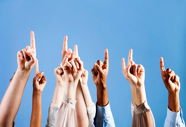 istock Many mixed hands point upwards into the blue 155076769