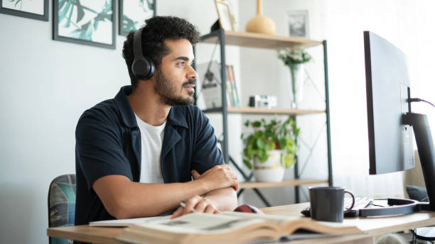 istock Smiling college student listening to online lecture 1550784570