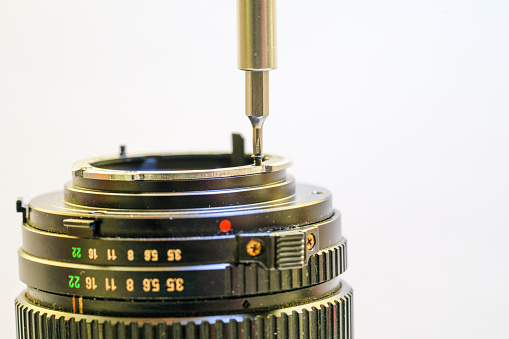 Back side of a dslr camera lens objective for professional photography with camera mount details in macro view with beautiful lens details for optical precision in portrait photography