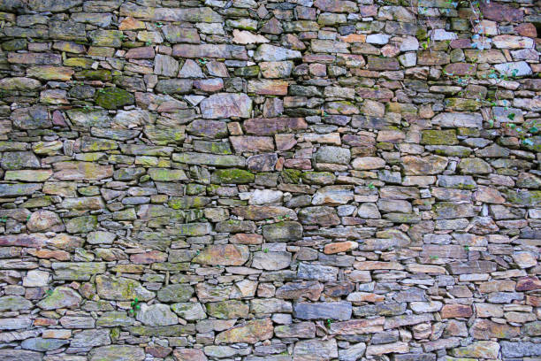 istock Big stone wall wallpaper, green, grey, orange 1550791625