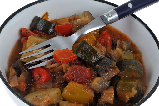Plate of homemade ratatouille with a fork close-up