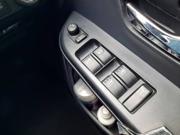 istock Window control buttons in modern car. Car window control panel. Modern car window switch. Door handle with power window control. 1550829172